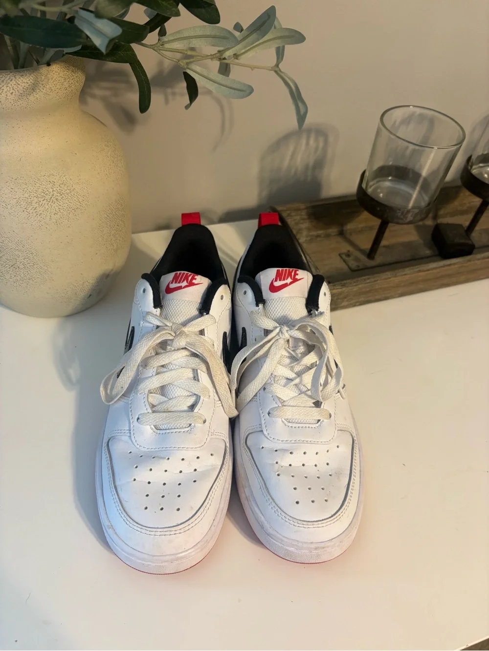 Nike White Low-Top Sneakers with Sparkly Black Swoosh and Red Accents